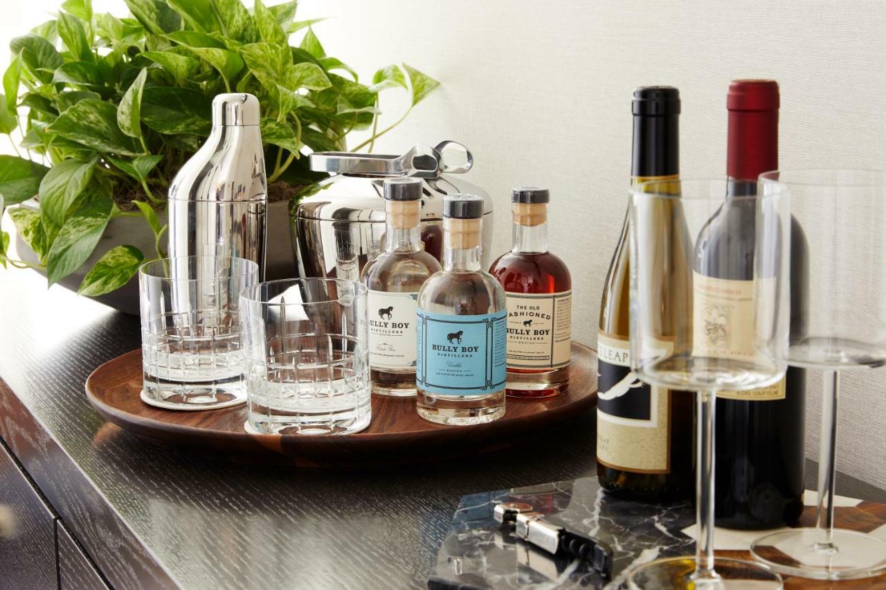 The Whitney Hotel Boston Exterior photo A bar cart with a selection of liquor and wine